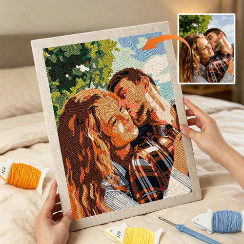 Embroidery of a couple holding each other with a small inset photo of the same couple.