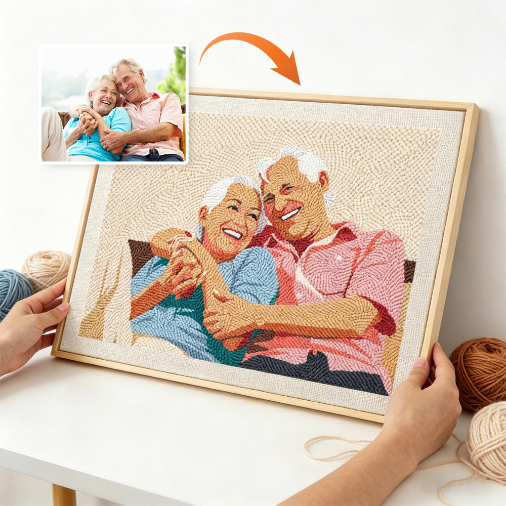 Framed needlepoint of an elderly couple holding hands, with a photo of them on the left.