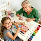 Woman and young girl working on a cross-stitch project together.