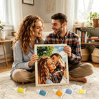 Couple holding a completed cross stitch of themselves in a cozy living room.