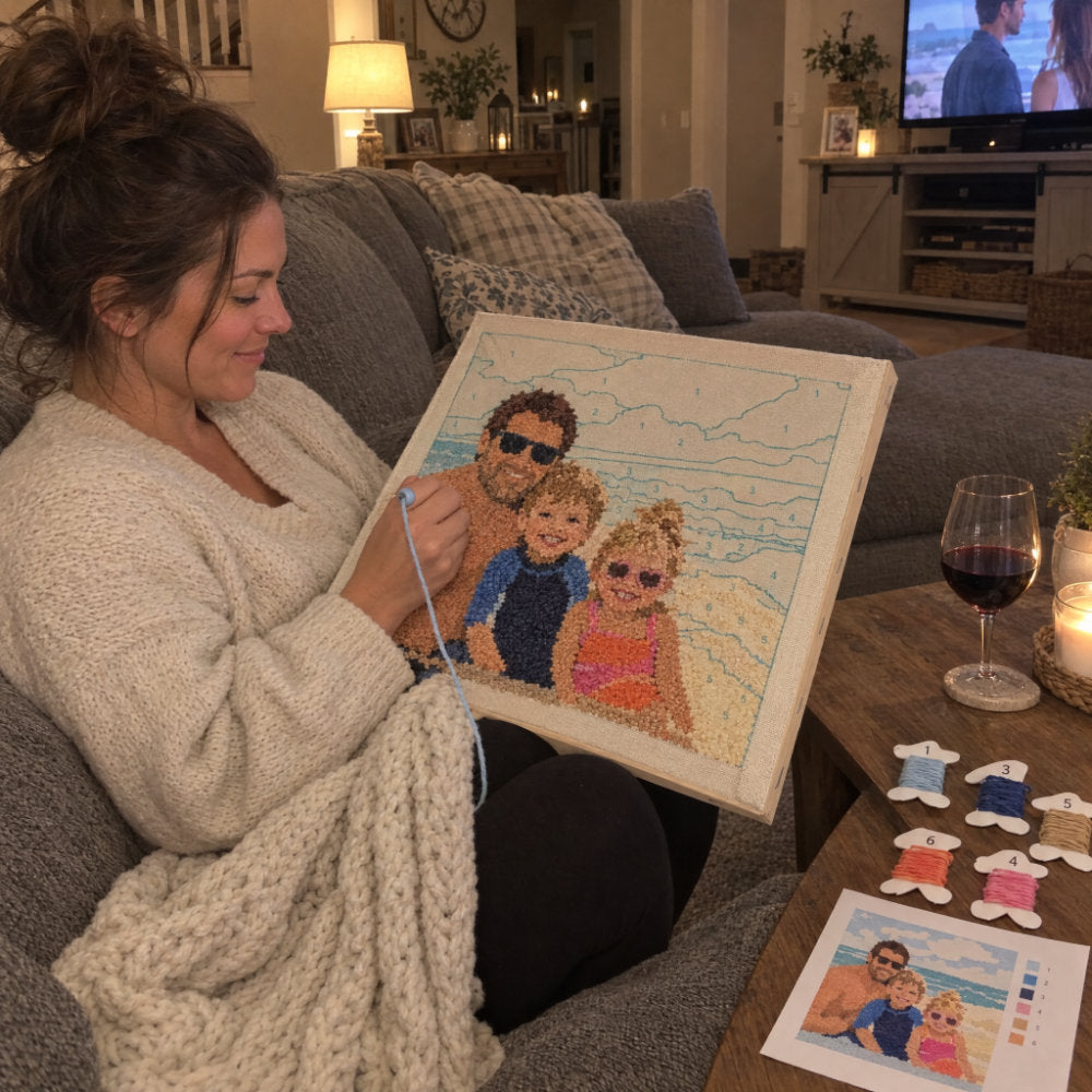 Woman relaxing on the couch while stitching her custom punch needle kit