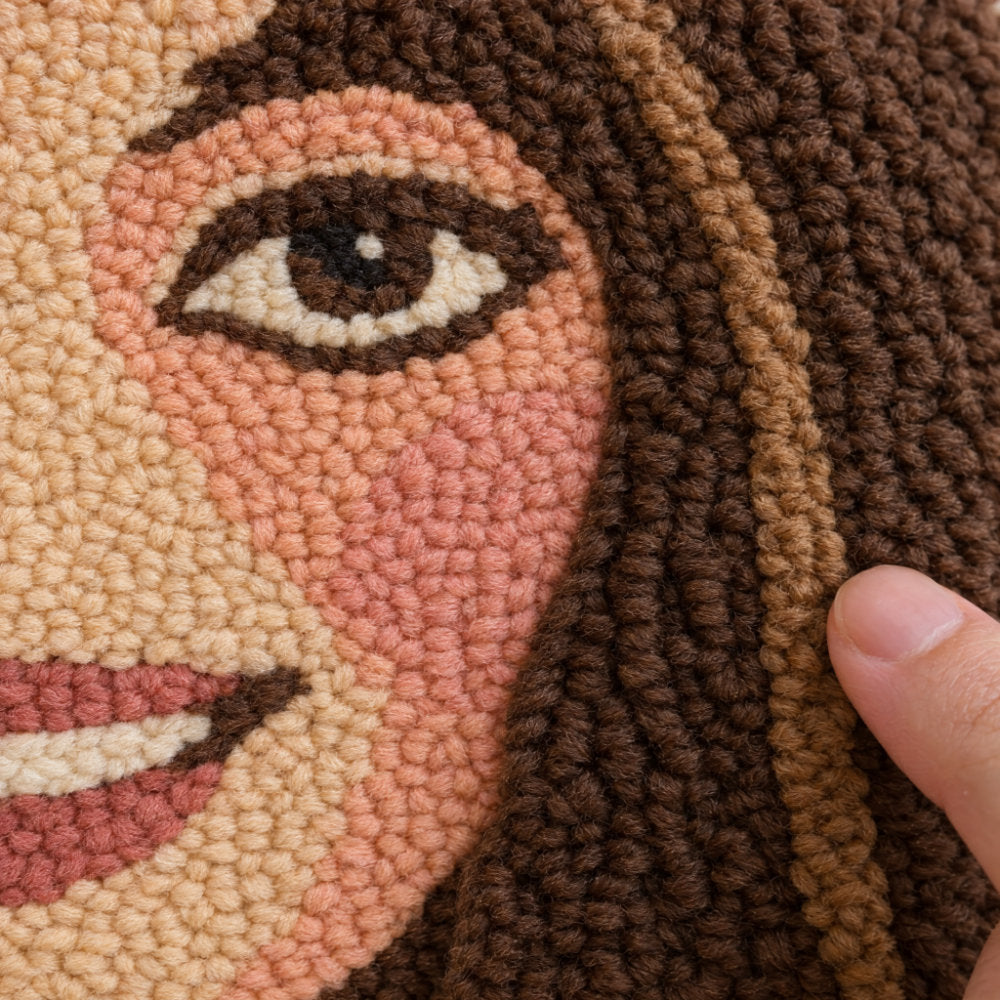 Detail of the soft, textured yarn loops of a custom punch needle portrait