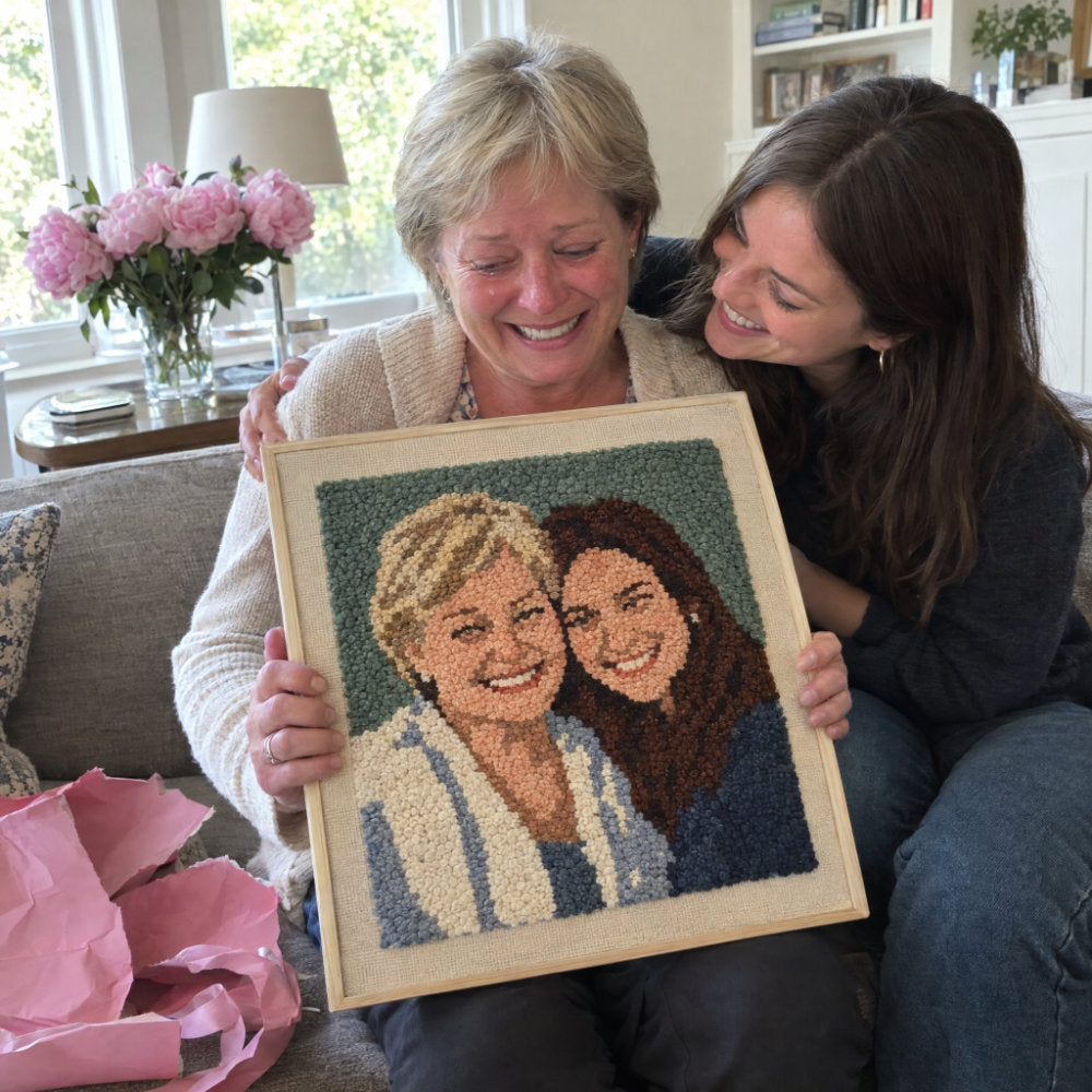 Mom with her custom punch needle portrait made from a family photo